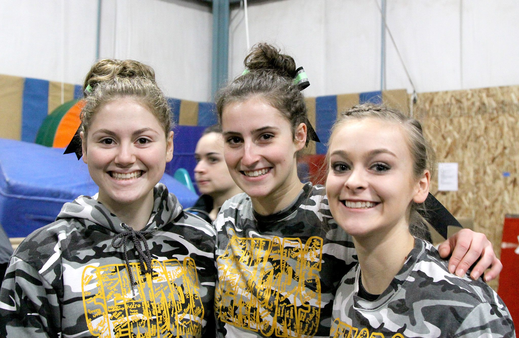 Dave Logan/for the Peninsula Daily News                                The Port Angeles gymnastics team seniors enjoy their home meet Monday. From left are Nikaila Price, Maya Wharton, and Laura Rooney.