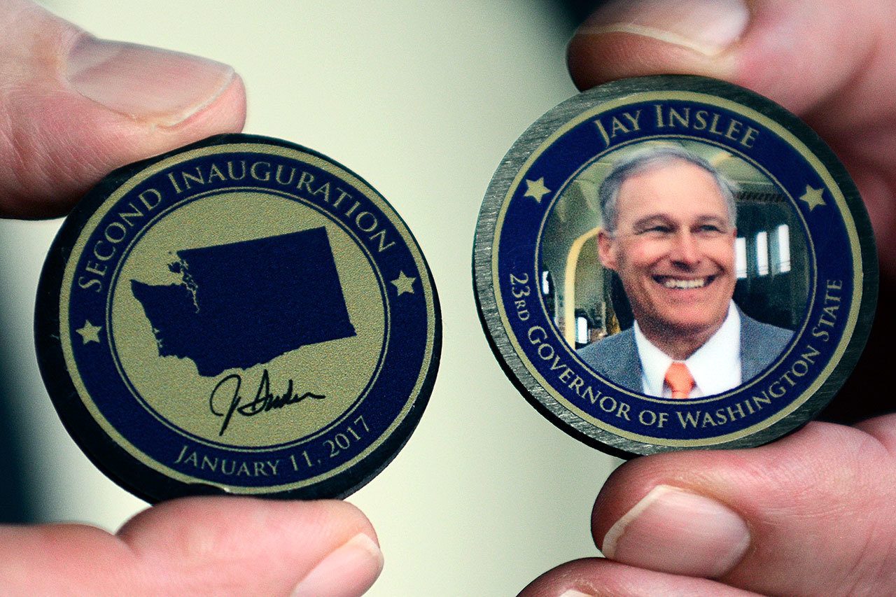 The Composite Recycling Technology Center created about 2,300 commemorative coins for Gov. Jay Inslee’s inauguration last week. (Jesse Major/Peninsula Daily News)