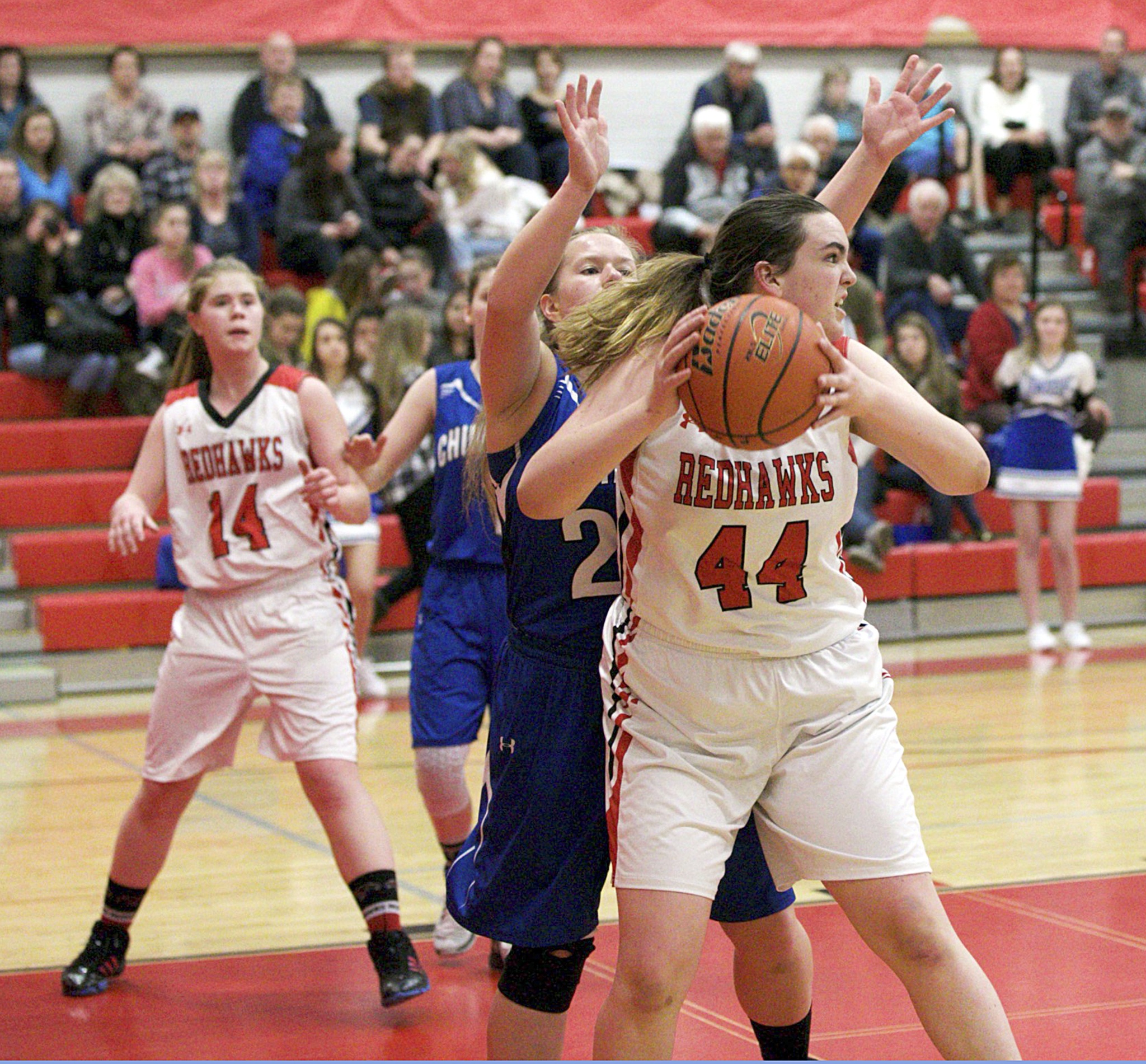 Steve Mullensky/for Peninsula Daily News                                PortTownsend’s Izzy Hammett looks for someone to pass the ball to while being guarded by Chimacum’s Shanya Nisbet during the Cowboys’ 42-28 win over the rival Redhawks.