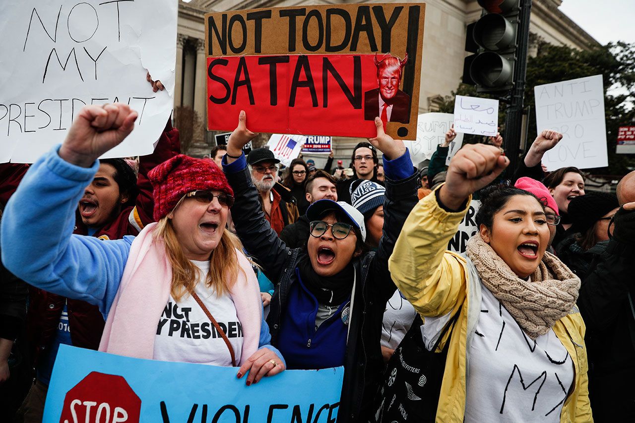 Protestors chant on the National Mall during a demonstration after the inauguration of President Donald Trump. (The Associated Press)