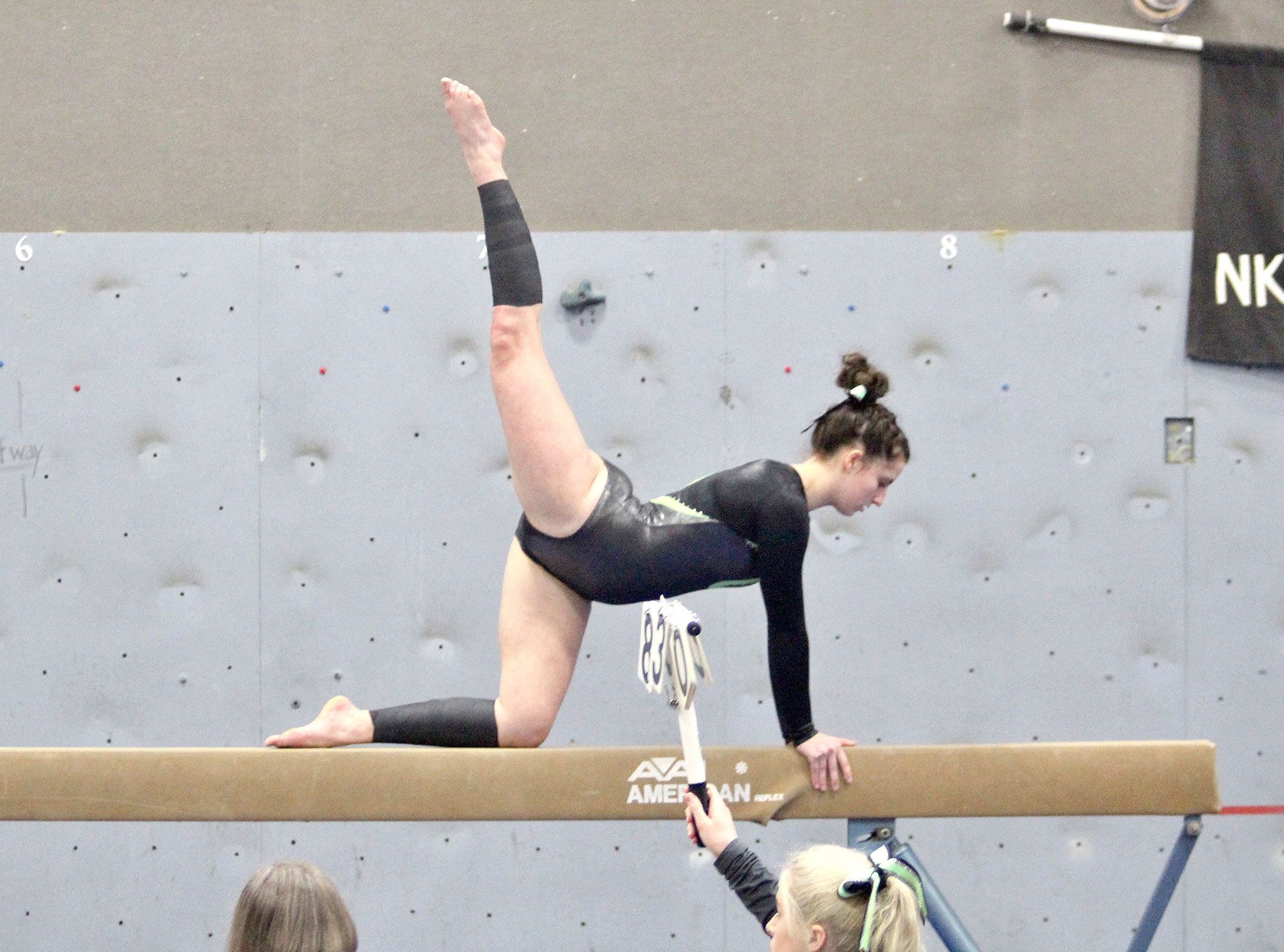 Port Angeles’ Maya Wharton competes on the beam during the Roughriders’ Friday meet against Kingston in Poulsbo.