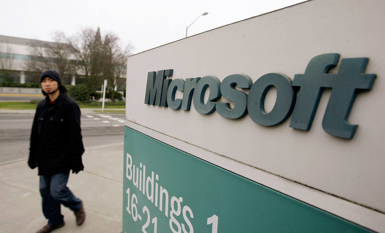 A man walks on the Microsoft headquarters campus in Redmond in 2009. The Justice Department is asking a federal judge to throw out a lawsuit filed by Microsoft that seeks to quash a law allowing the government to demand customer data stored electronically while prohibiting Microsoft from exposing the requests. (AP Photo/Elaine Thompson, File)