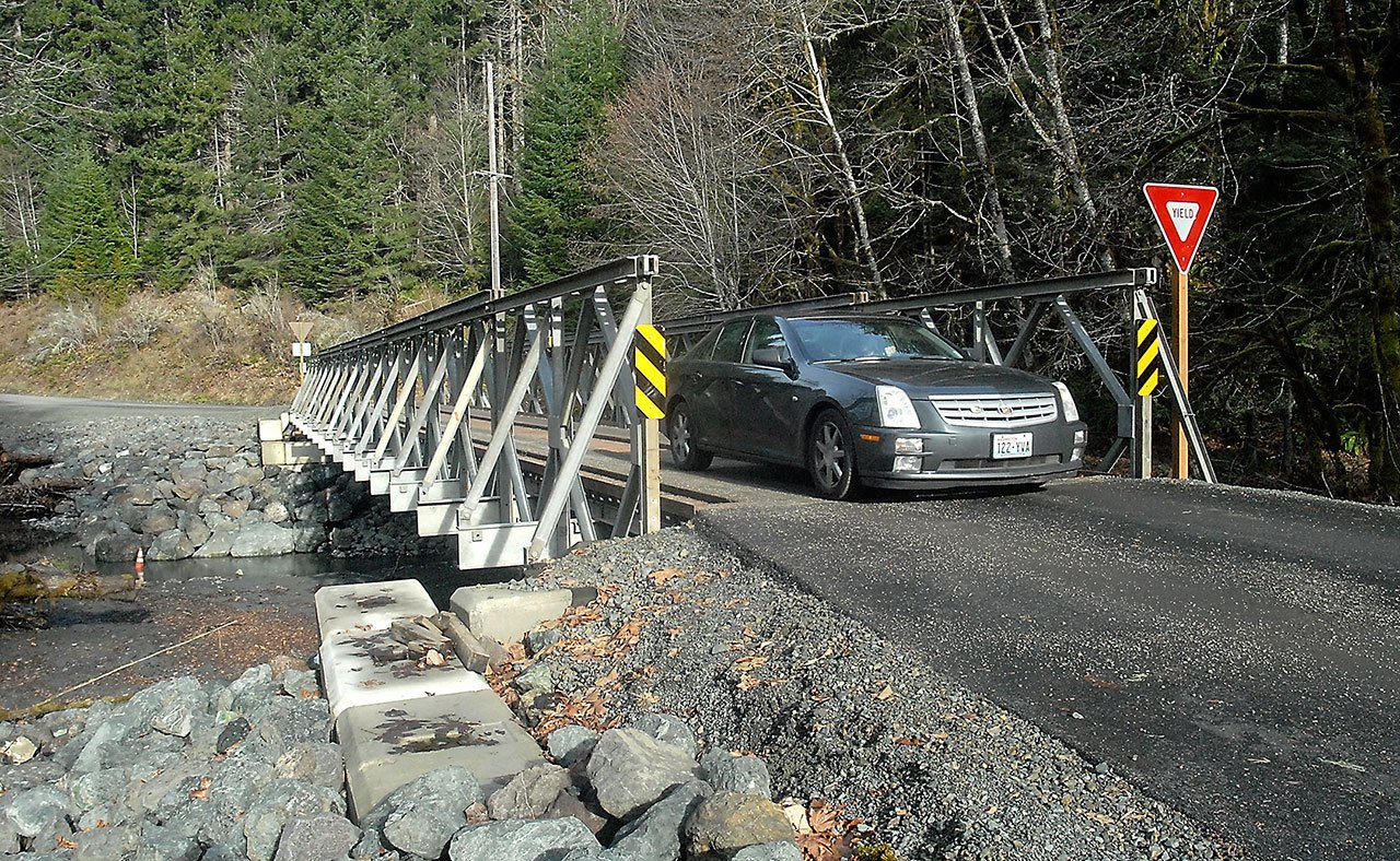 A car makes its way across a recently installed one-lane bridge over a side channel of the Elwha River in Olympic National Park on Thursday after the park service reopened the Elwha Valley to visitors. (Keith Thorpe/Peninsula Daily News)