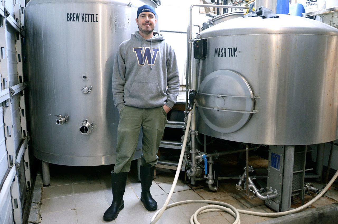 Port Townsend Brewing head brewer Carter Camp has been infusing beer for roughly two weeks to prepare a strange brew for Strange Brewfest. (Cydney McFarland/Peninsula Daily News)
