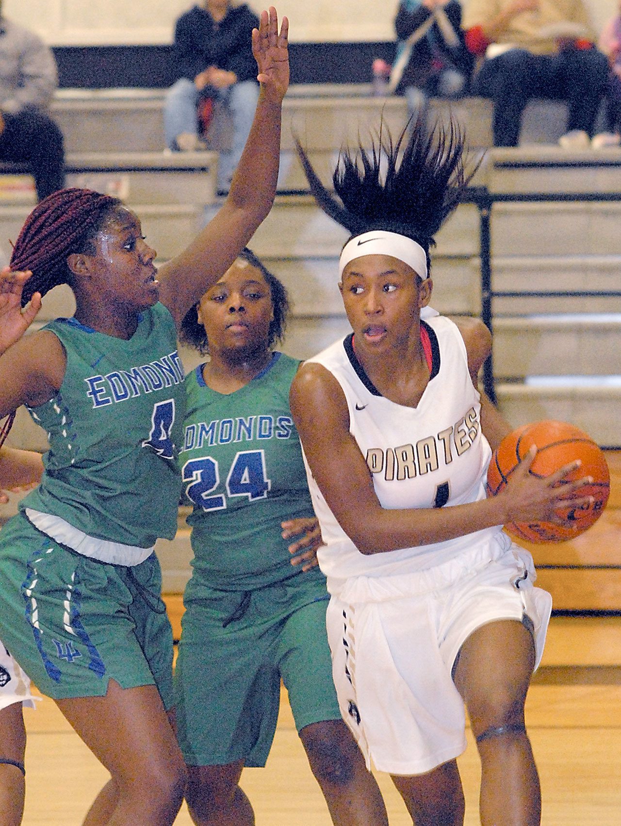 Keith Thorpe/Peninsula Daily News Peninsula’s Anaya Rodisha, right, drives through the lane as Edmonds’ Damaiya Ward, left, and Montasia Brown defend during the second quarter on Saturday night in Port Angeles.