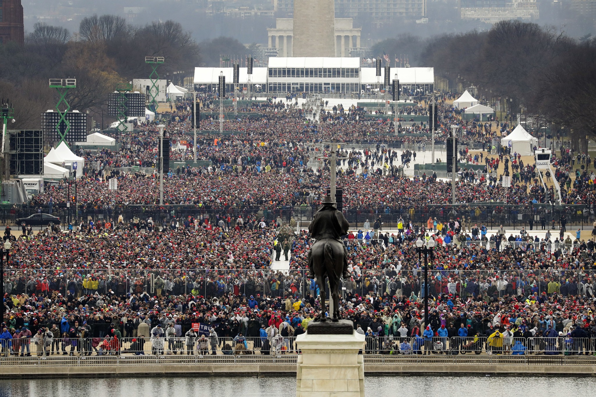 People stand on the National Mall to listen to the 58th Presidential Inauguration for President Donald Trump at the U.S. Capitol in Washington, D.C. (The Associated Press)