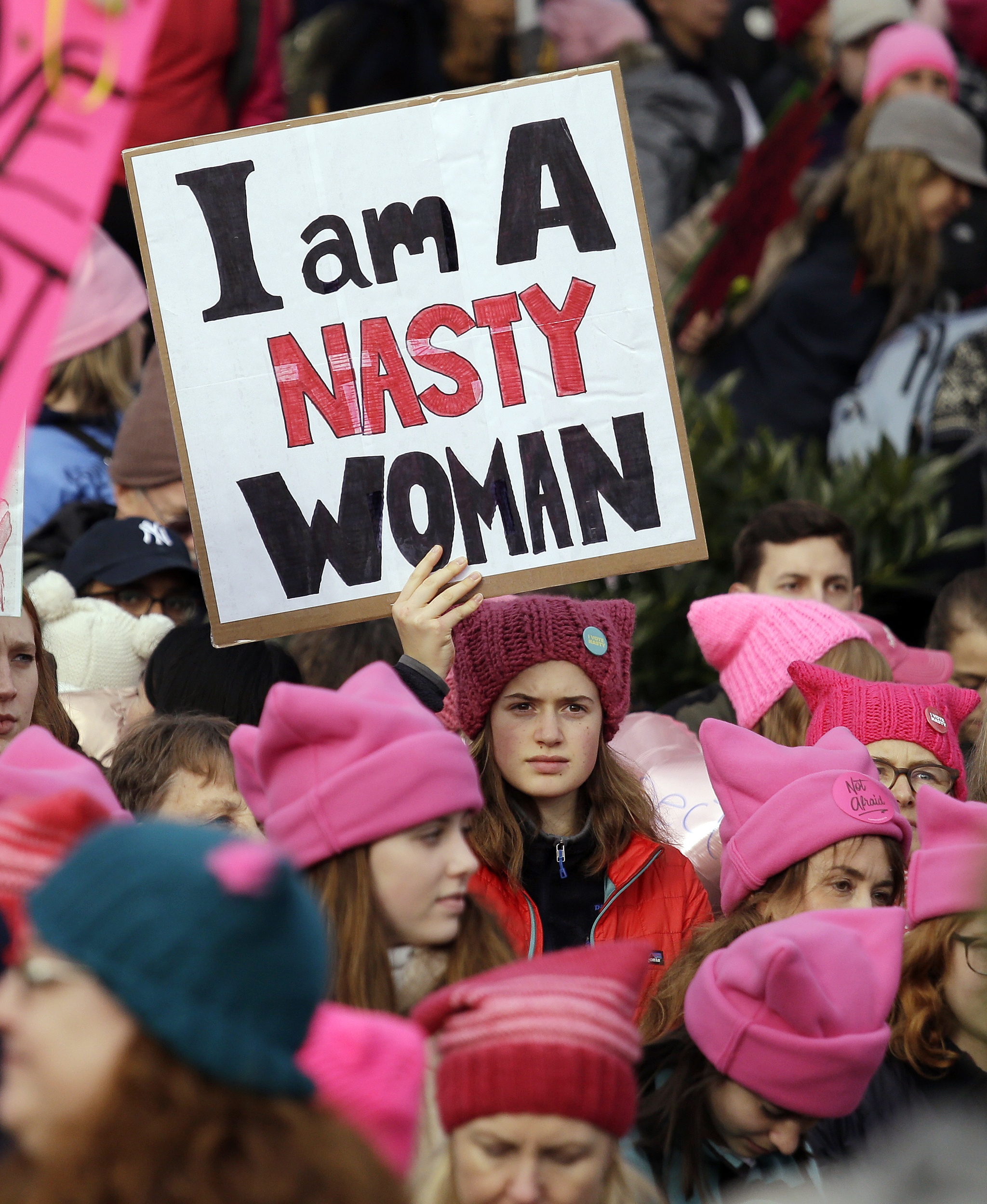 A woman holds a sign amidst a sea of pink caps before a women’s march Saturday in Seattle. Women across the Pacific Northwest marched in solidarity with the Women’s March on Washington and to send a message in support of women’s rights and other causes. (Elaine Thompson/The Associated Press)