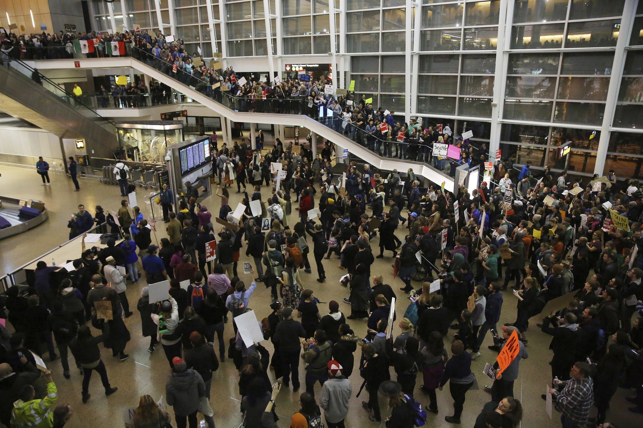 More than 1,000 people gather Saturday at Seattle-Tacoma International Airport to protest President Donald Trump’s order that restricts immigration to the U.S. (Genna Martin/seattlepi.com via AP)