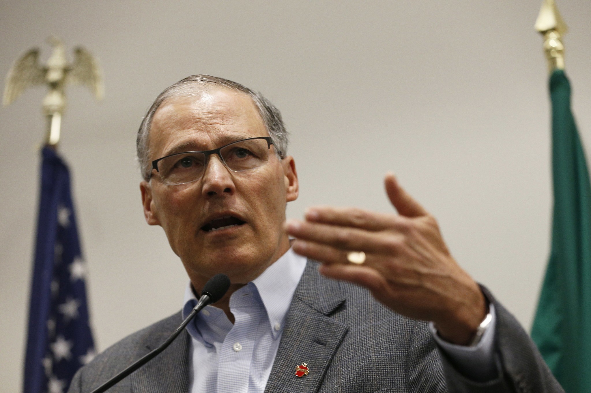 Gov. Jay Inslee speaks to the media in the Airport Office Building at Seattle-Tacoma International Airport on Saturday. (Logan Riely/The Seattle Times via AP)