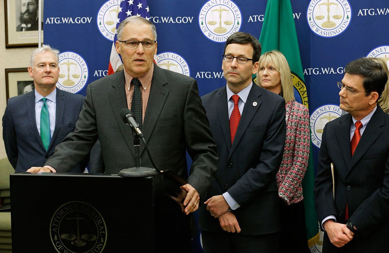 Gov. Jay Inslee speaks Monday during a news conference at the Capitol in Olympia to announce that he and Attorney General Bob Ferguson, third from left, have proposed legislation to abolish the death penalty in Washington state. (Ted S. Warren/The Associated Press)