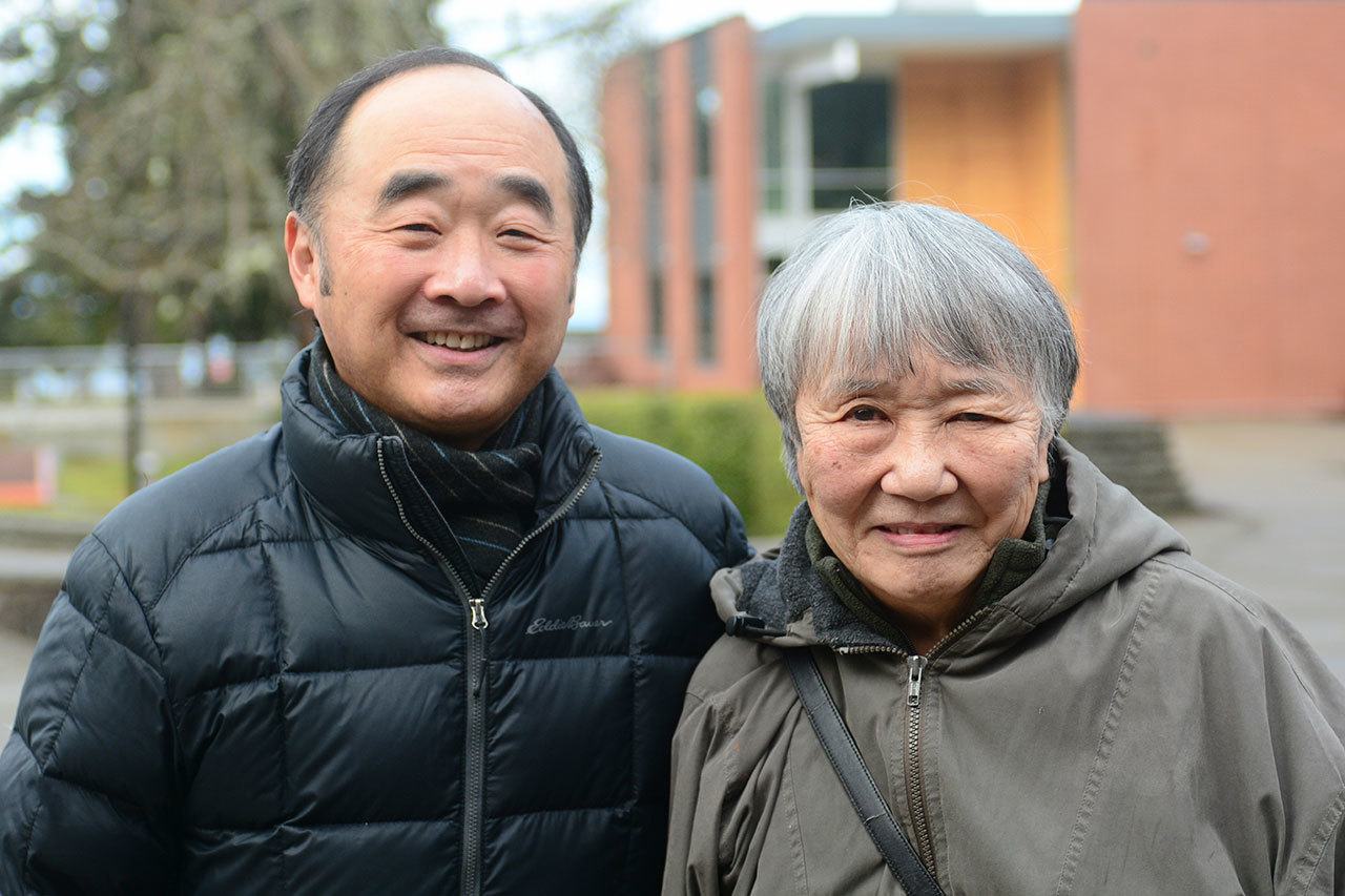 Clarence Moriwaki, president of Bainbridge Island Japanese American Community, stands with Lilly Kodama of Bainbridge Island, who was one of the first Japanese Americans forced into an internment camp 75 years ago. (Jesse Major/Peninsula Daily News)