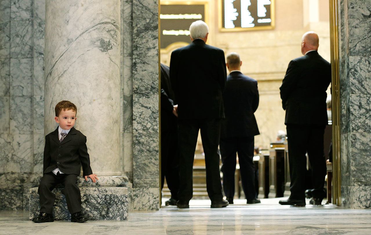 William Griffey, 3, left, grandson of state Rep. Dan Griffey, R-Allyn, waits outside the House chamber Monday on the opening day of the legislative session at the Capitol in Olympia. (Ted S. Warren/The Associated Press)