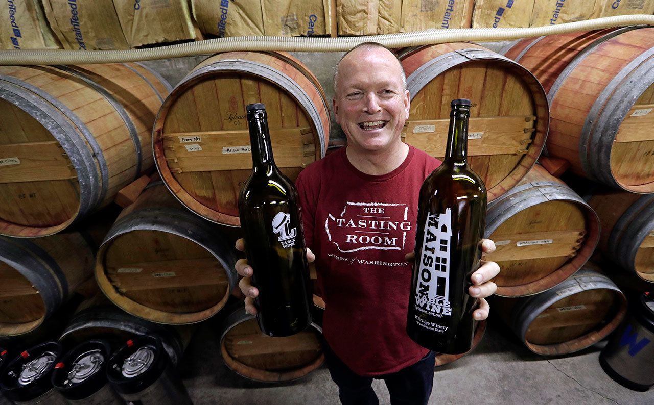 Winemaker Paul Beveridge displays the type of wine “growler” bottle he would like to see available to consumers, at his winery in Seattle on Tuesday. (Elaine Thompson/The Associated Press)