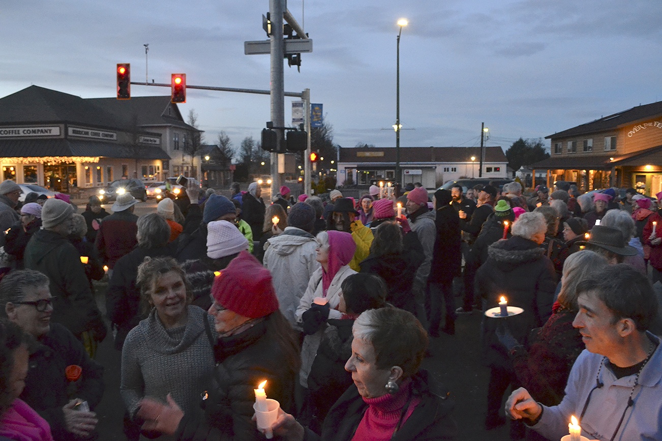 People gather last Saturday at the southeast corner of Washington Street and Sequim Avenue for women’s rights. Organizers estimate more than 100 people attended. (Matthew Nash/Olympic Peninsula News Group)