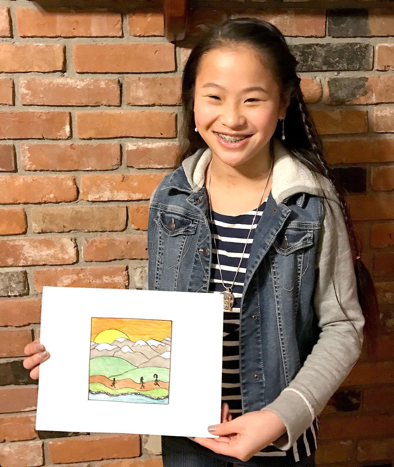 Lilly Sanders, 12, and her winning medal design for the North Olympic Discovery Marathon.