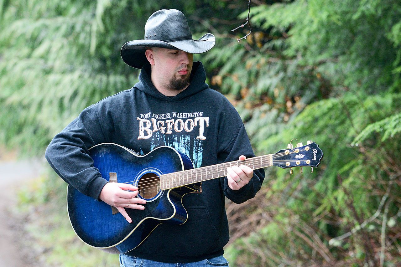 Port Angeles musician Eric Lawton struck a chord with locals after writing a song called &ldquo;Pacific Northwest,&rdquo; which garnered almost 60,000 hits online over a few days. (Jesse Major/Peninsula Daily News)
