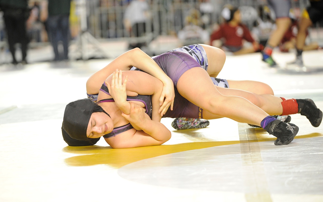Michael Dashiell/Olympic Peninsula News Group                                Sequim’s Alma Mendoza, bottom, won her 155-pound match with a third-period reversal to defeat Pasco’ Natalie Hall at Mat Classic, the state wrestling championships. Mendoza wrestled for the state title Saturday evening.