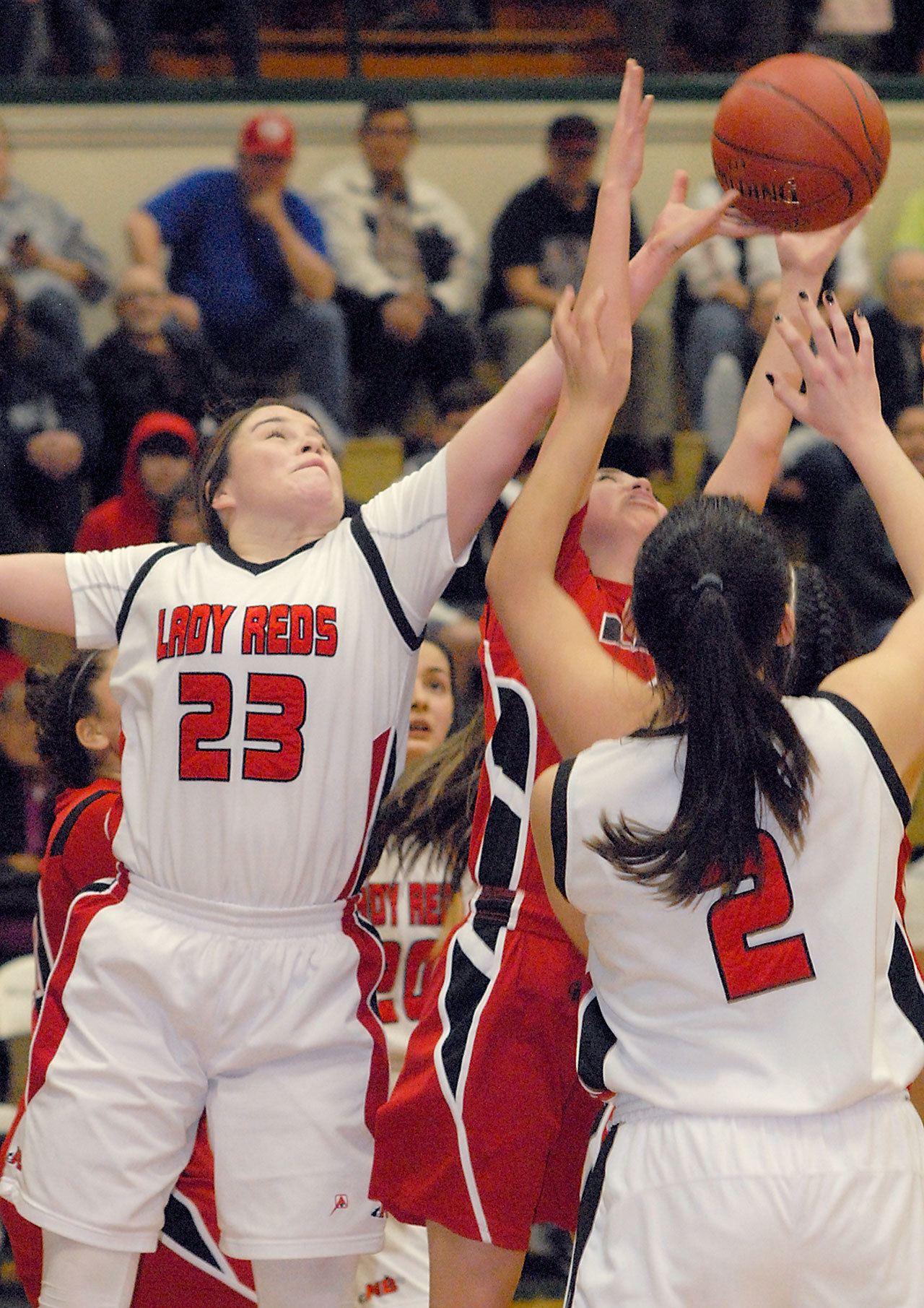 Keith Thorpe/Peninsula Daily News Neah Bay’s Tristin Johnson, left, and Kayla Winck, right, compete for a rebound with Tulalip Heritage’s Myrna Redleaf during the fourth quarter of Thursday night’s playoff game at Port Angeles High School.                                Keith Thorpe/Peninsula Daily News Neah Bay’s Tristin Johnson, left, and Kayla Winck, right, compete for a rebound with Tulalip Heritage’s Myrna Redleaf during the fourth quarter of Thursday night’s playoff game at Port Angeles High School.
