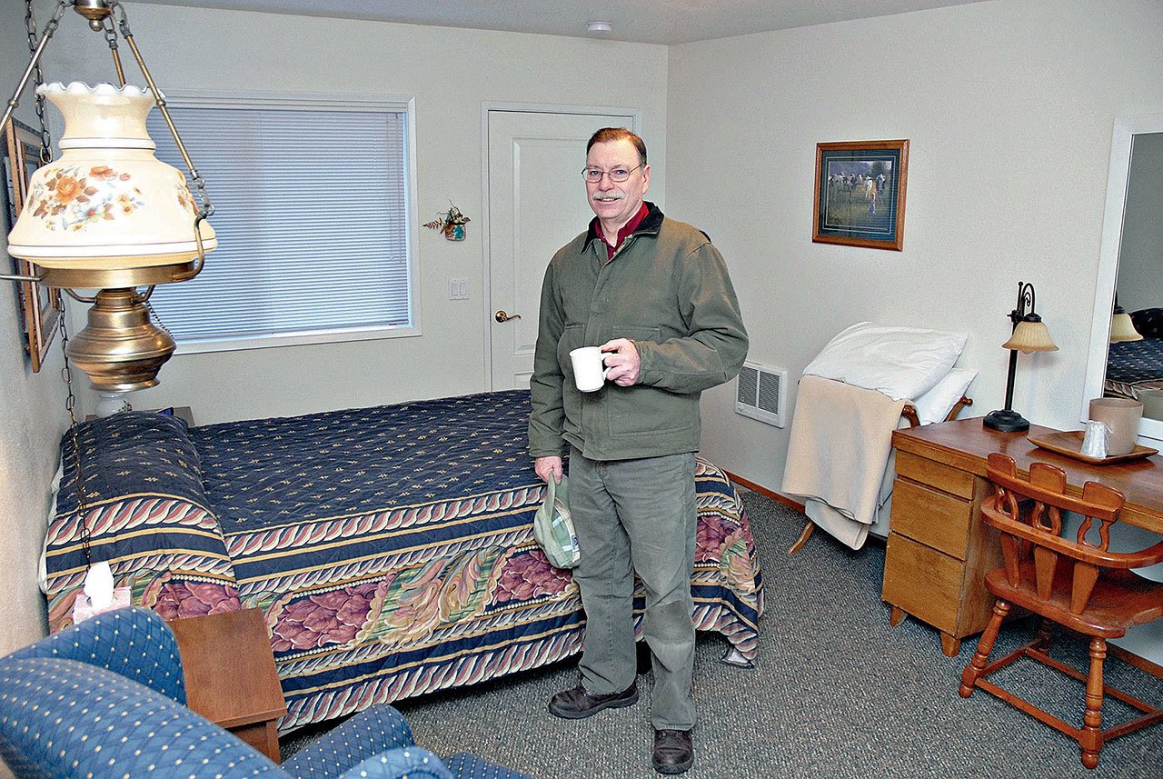 Terry Roszatycki stands inside one of the renovated rooms at the Indian Valley Motel in January 2011. The room had been damaged by fire in February 2010. (Peninsula Daily News)