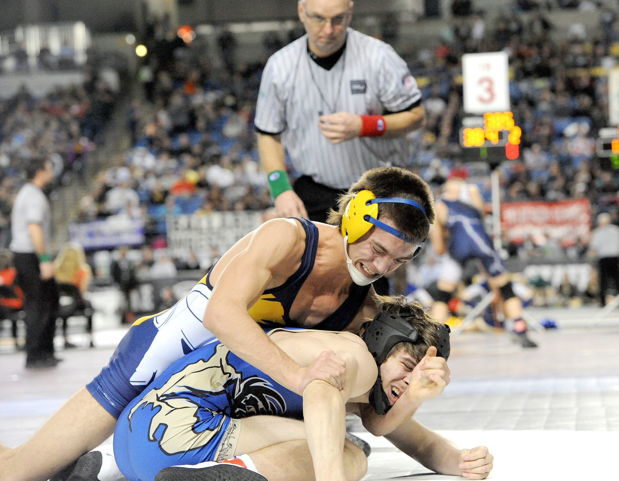 Lonnie Archibald/for Peninsula Daily News Forks’ Garrison Schumack, in top position, defeats Ethan Newman of Deer Park to place third in the 1A division’s 145-pound class at Mat Classic XXIX in the Tacoma Dome.