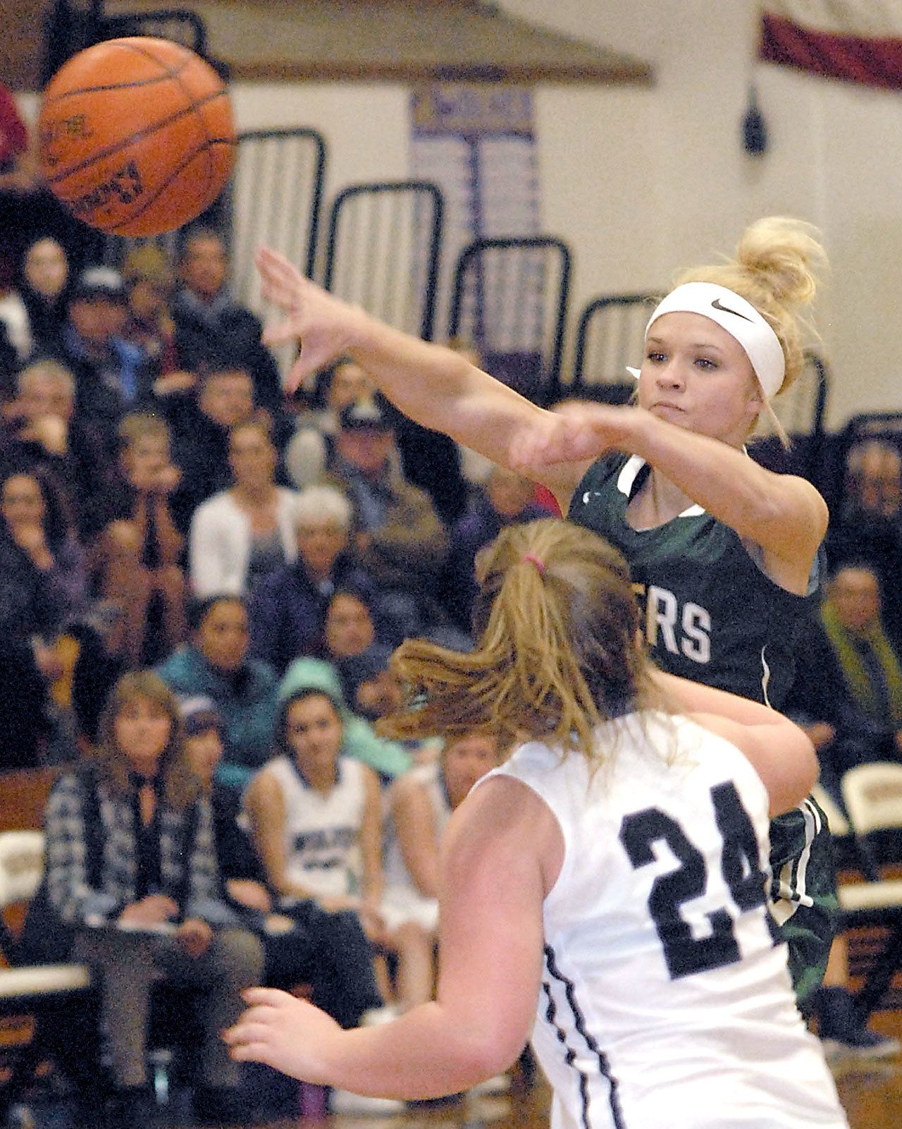 Keith Thorpe/Peninsula Daily News Port Angeles’ Natalie Steinman, top, passes past Sequim’s Madison Green during the Roughriders’ win in Sequim earlier this season.