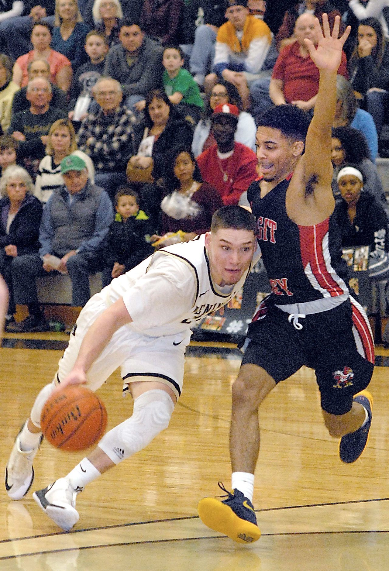 Keith Thorpe/Peninsula Daily News                                Peninsula’s Cole Rabedeaux, left, drives as Skagit Valley’s Tyler Kidd defends during the Pirates’ 89-87 NWAC North Division loss to the Cardinals.