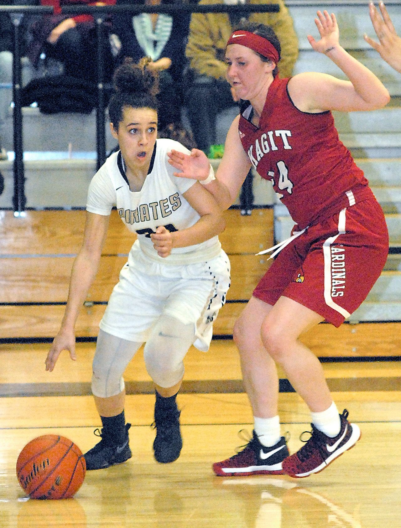 Keith Thorpe/Peninsula Daily News Peninsula&rsquo;s Sephora Yayouss slides past Skagit Valley&rsquo;s Emily Yost in the fourth quarter of Wednesday night&rsquo;s matchup in Port Angeles.