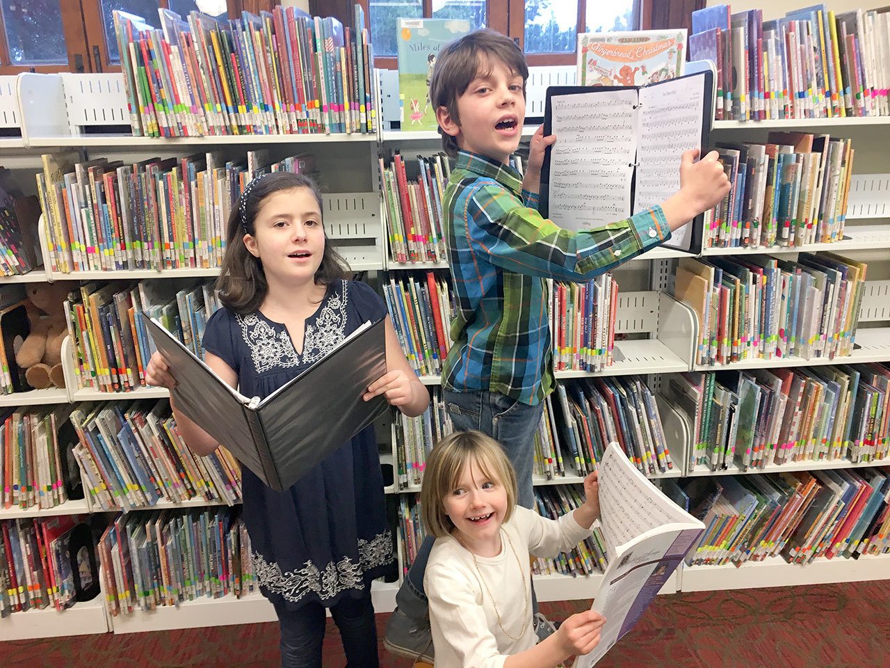 From left, Dare Bailey, Lila Morgan and Tristan Erickson tune up for next week’s first meeting of the Port Townsend Public Library Children’s Choir. (Phina Pipia)