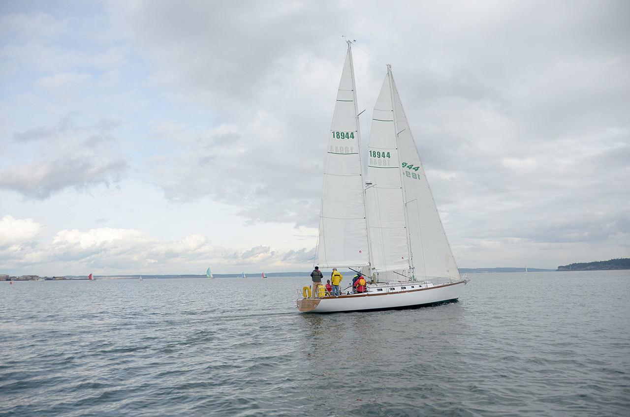 The winning boat, Sir Isaac, crosses the finish line in the middle of Port Townsend Bay on Saturday. Sir Isaac was the only boat to finish in under an hour and held a wide lead through the entire race after crossing the starting line first. (Cydney McFarland/Peninsula Daily News)