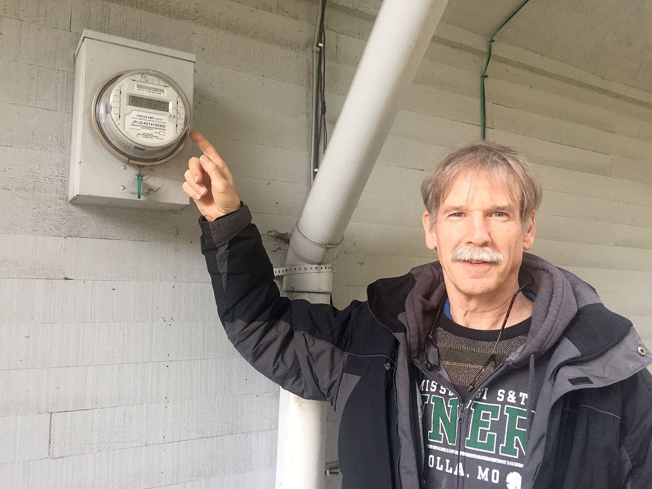 Jim Parker, general manager of the Jefferson County PUD, shows off the new digital meters that will replace the outdated mechanical models used by most PUD customers. (Cydney McFarland/Peninsula Daily News)