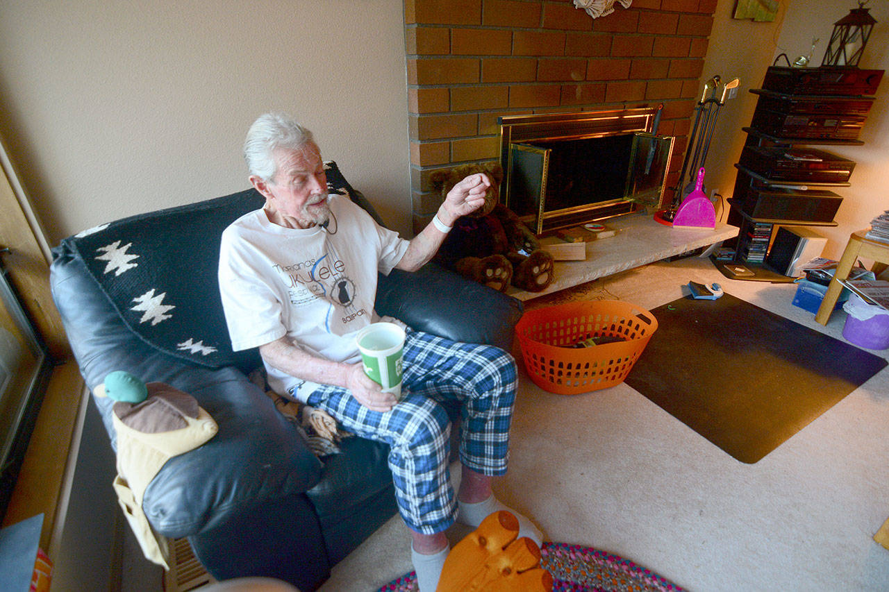 Richard Jones, 69, talks to reporters in his Sequim-area home Monday after being rescued from his car earlier that morning. He was trapped in his car for five days. (Jesse Major/Peninsula Daily News)