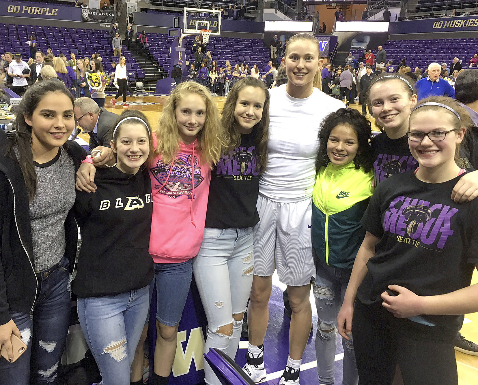 Members of the Olympic Avalanche Black basketball team attend a historic University of Washington women’s game Sunday in which Kelsey Plum scored 57 points to become the all-time NCAA scoring leader. From left, Courtney Swan, Khloe Stanard, Emilia Long, Hannah Reetz, University of Washington player Katie Collier, Camille Stensgard, Jaida Wood and Myra Walker.