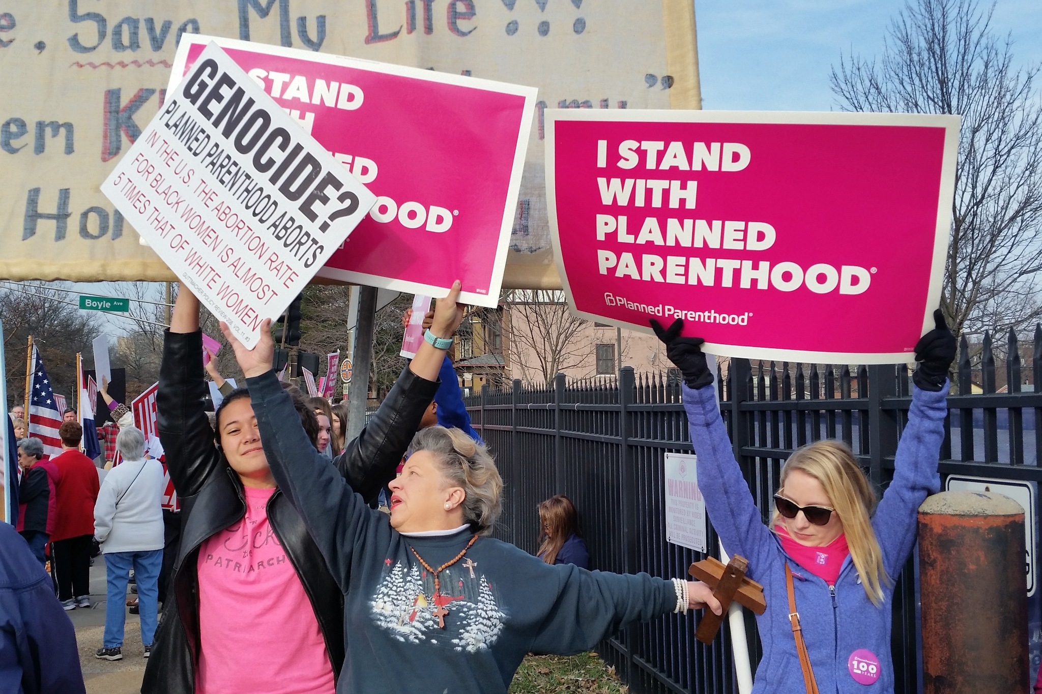 A Planned Parenthood supporter and opponent try to block each other’s signs during a protest and counter-protest Saturday in St. Louis. Rallies aimed at urging Congress and President Donald Trump to end federal funding for Planned Parenthood were scheduled across the country. (Jim Salter/The Associated Press)