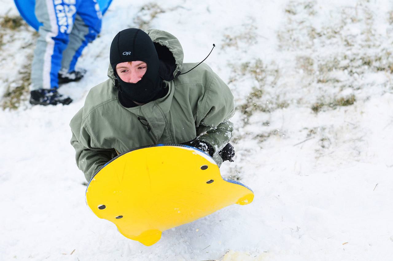 Cyras Mills, 13, sleds on a hill at Stevens Middle School in Port Angeles on Monday. (Jesse Major/Peninsula Daily News)
