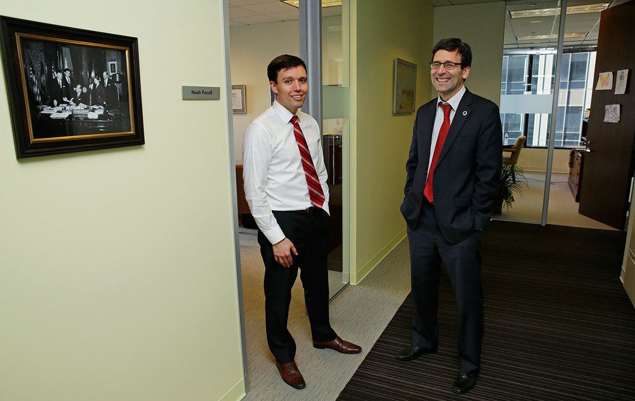 Washington state Solicitor General Noah Purcell, left, and Attorney General Bob Ferguson, right, pose Friday next to their adjoining offices in Seattle. (Ted S. Warren/The Associated Press)
