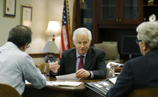 Washington Insurance Commissioner Mike Kreidler, center, conducts a meeting in his office Feb. 8 at the Capitol in Olympia. (Ted S. Warren/The Associated Press)
