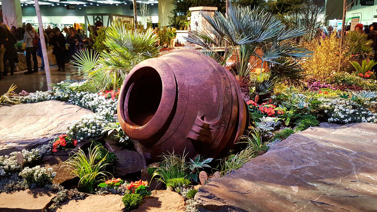 The use of a gigantic terra cotta pot among the large flat boulders as a water feature helped Jefferson Landscaping win this year’s prestigious “Founders Award” at the 29th annual Northwest Flower & Garden Show. (Andrew May/for Peninsula Daily News)