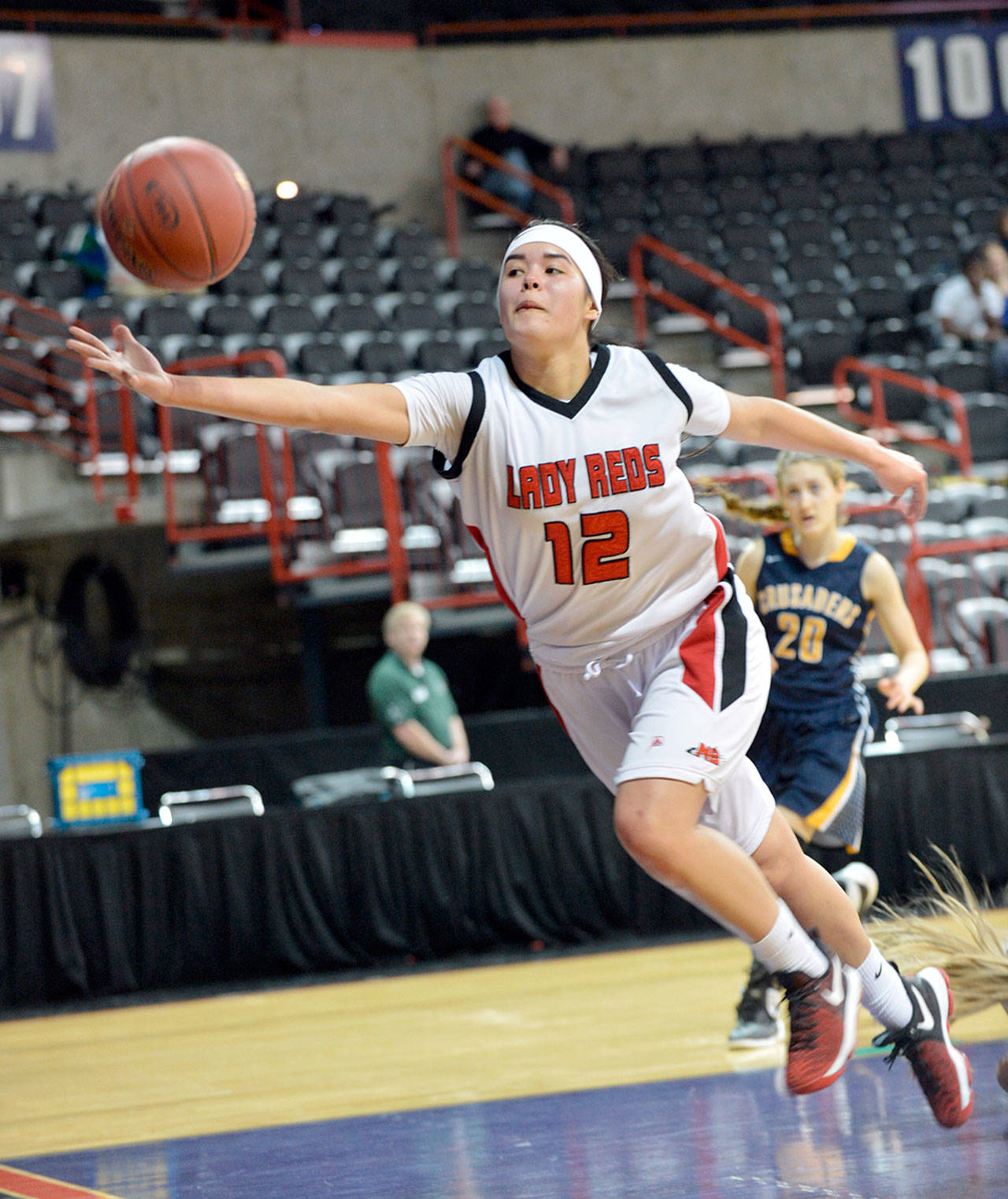 Al Camp/Omak Chronicle Neah Bay&rsquo;s Vonte Aguirre reaches for a loose ball during the Red Devils&rsquo; 60-57 loss to Tacoma Baptist in the Class 1B girls basketball state tournament Friday at Spokane Arena.