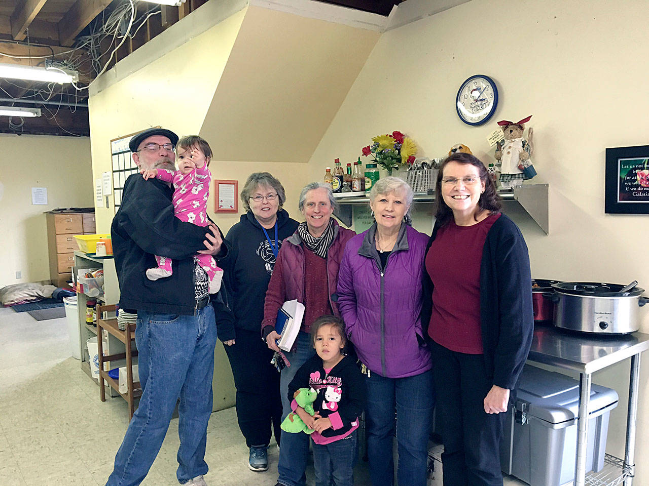 From left, Martin Shaughnessy, TAFY volunteer, holding Mara Northrop; Karen Beck, TAFY volunteer; Betsy Wharton, TAFY volunteer registered nurse and gardener; Mara&rsquo;s sister Mackenzie Northrop; Susan Hillgren, TAFY executive director; and Pam Fosnes, TAFY volunteer financial director. (Vivian Elvis Hansen/Peninsula Daily News)