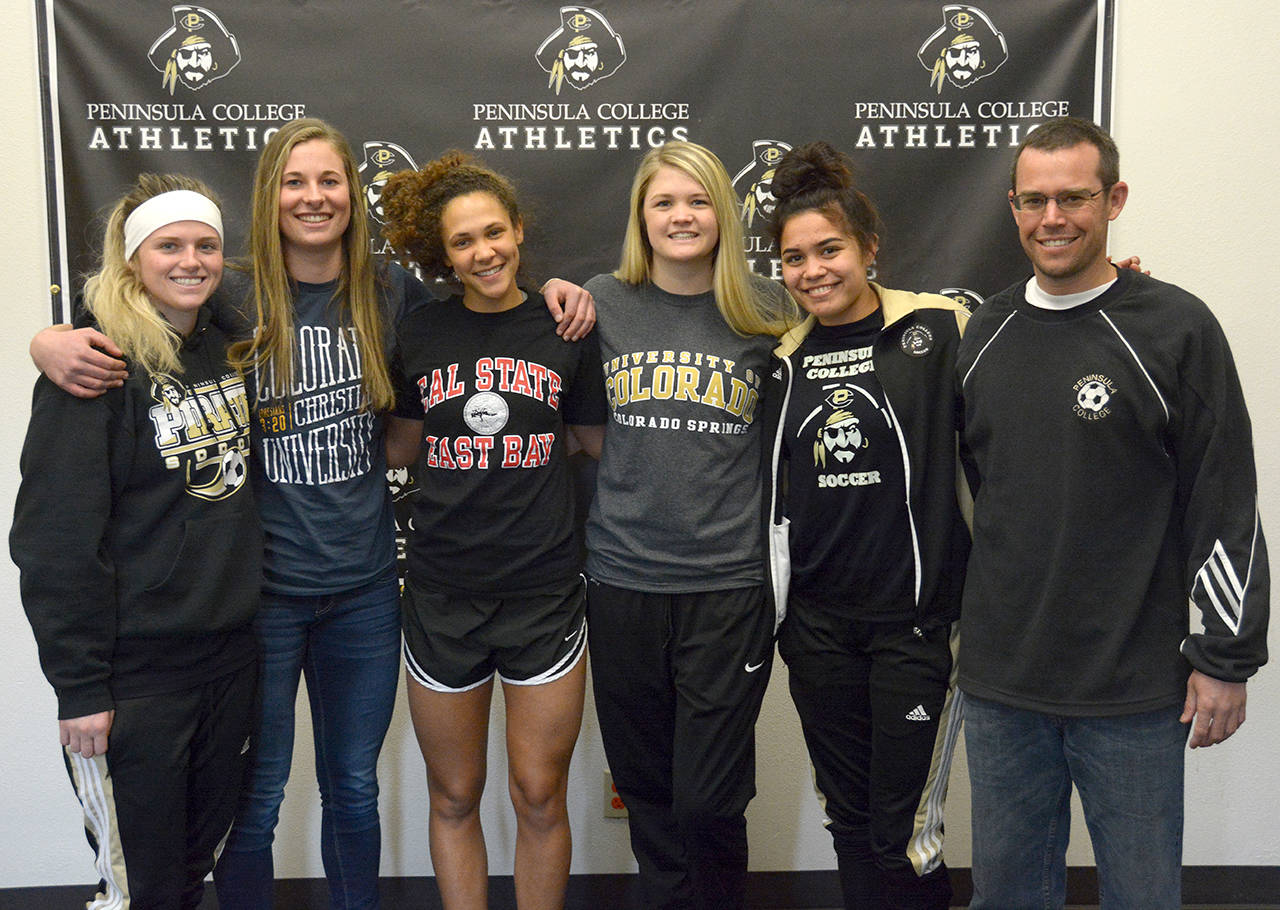 Peninsula College Athletics Peninsula College women’s soccer players have signed to continue their playing careers at four-year colleges and universities. From left, Aubrey Barham, Heidi Vereide, Bri Vallente, Bailie Zuber, Hoku Afong and Pirates head coach Kanyon Anderson. Kennady Whitehead, not pictured, also signed with a four-year university.