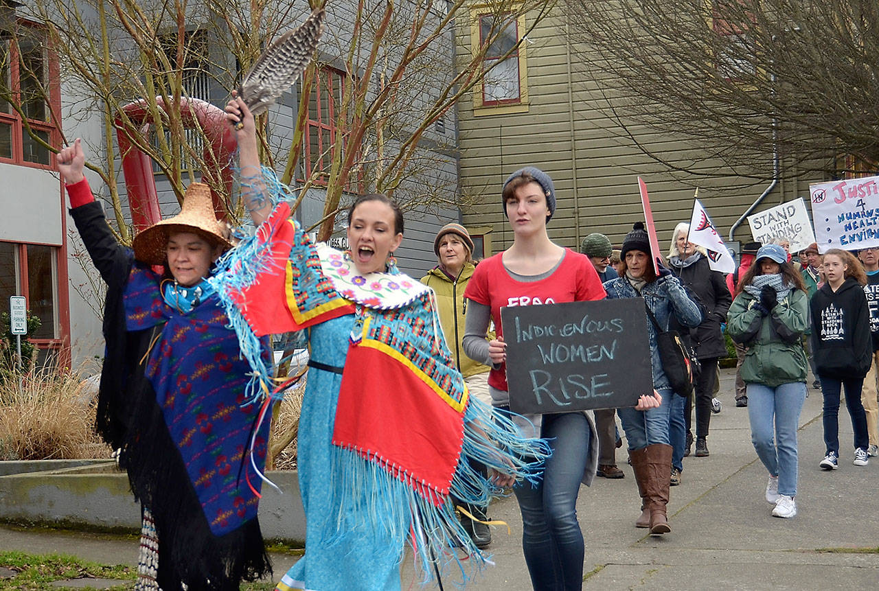 Carmen Bitzer, left, and Sabrina Hill lead a march through Port Townsend on Friday in solidarity with a march in Washington, D.C., to protest the Dakota Access pipeline. (Cydney McFarland/Peninsula Daily News)
