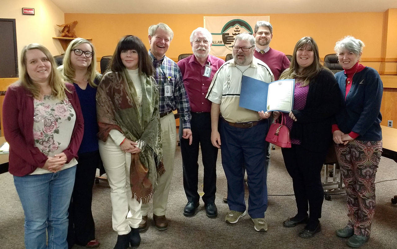 Clallam County commissioners proclaimed March as Developmental Disabilities Awareness Month on March 7. Pictured with the proclamation are, from left, Cindy Sump, parent of a daughter with autism spectrum disorder; Shawnda Hicks, Clallam Mosaic’s parent-to-parent coordinator; Kelley Lawrence, Clallam County Health and Human Services developmental disabilities employment coordinator; Randy Johnson, Clallam County commissioner; Timothy Bruce, Clallam County Health and Human Services planner; Patrick McFarland, DDAC member and Special Olympics participant; Mark Ozias, county commissioner; Randi Jones of Pierce Jones & Associates; and Mary Jane Duncan, Clallam Mosaic board member. (Nan Furford)
