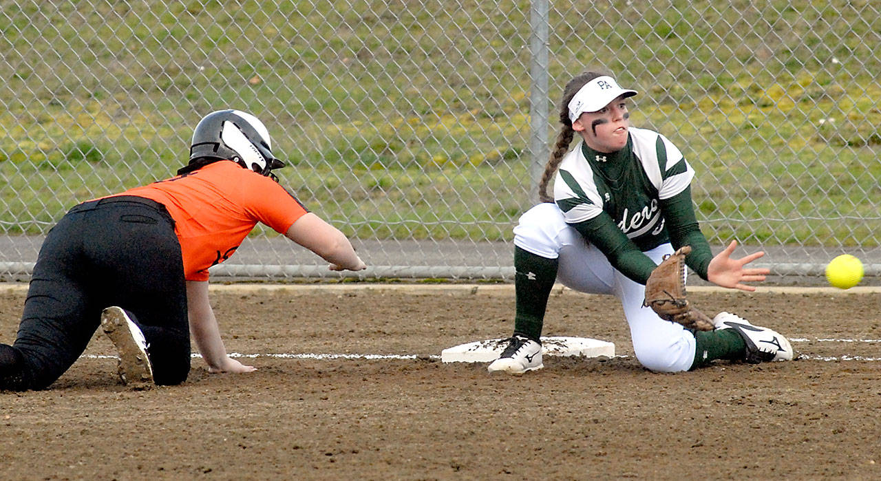 Keith Thorpe/Peninsula Daily News Port Angeles first baseman Kylee Reid, right, tries to catch Central Kitsap’s Marissa Adams off the bag during the first inning on Tuesday at the Dry Creek athletic fields in Port Angeles.
