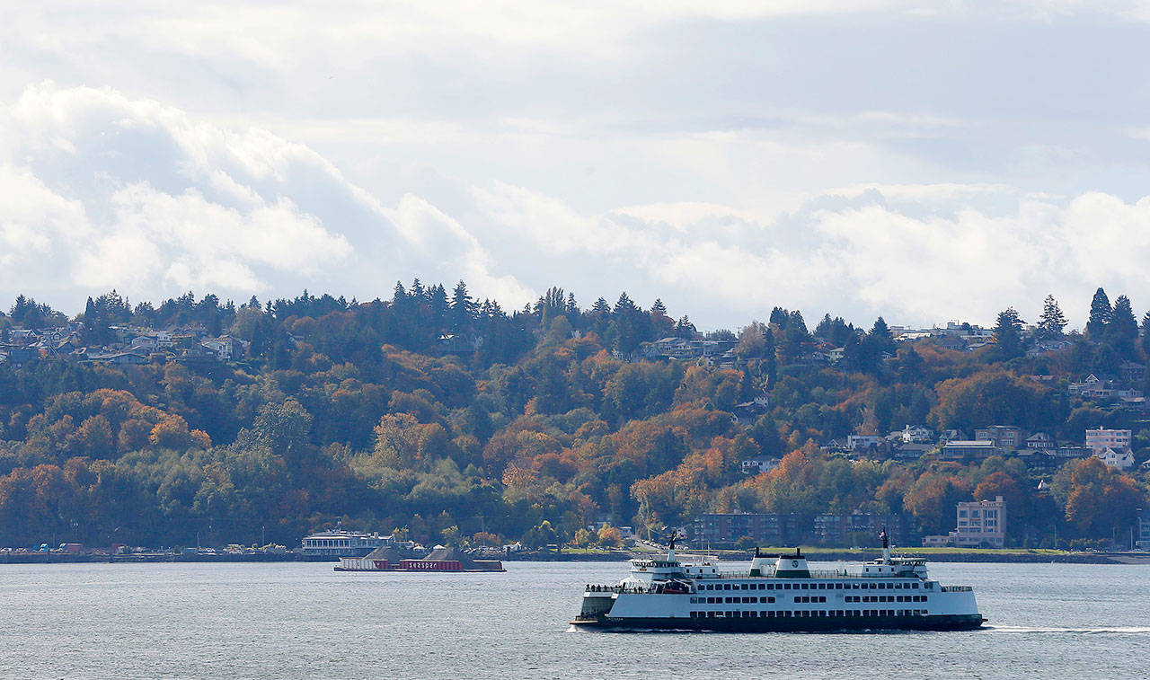 A Washington state ferry sails on Elliott Bay, which is part of Puget Sound, near West Seattle this past October. Washington state officials, environmental advocates and others are warning of dire environmental and economic consequences if President Donald Trump’s cuts to Puget Sound and other environmental programs go through as proposed in his budget that was released last Thursday. (Ted S. Warren/The Associated Press)