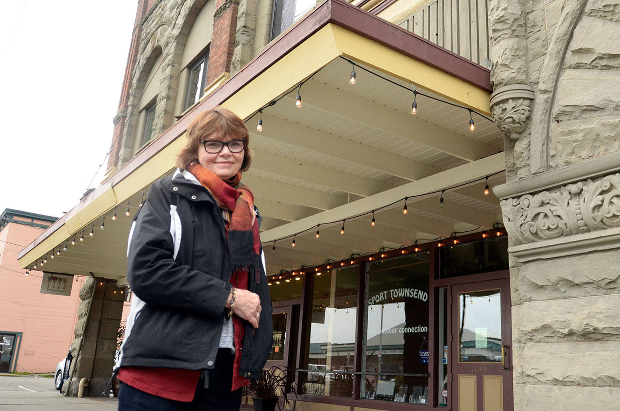 Mari Mullen, director of the Port Townsend Main Street Program, stands in front of the historic Kuhn Building, which was a recipient of a loan in order to fix all the windows on the building’s second story. (Cydney McFarland/Peninsula Daily News)