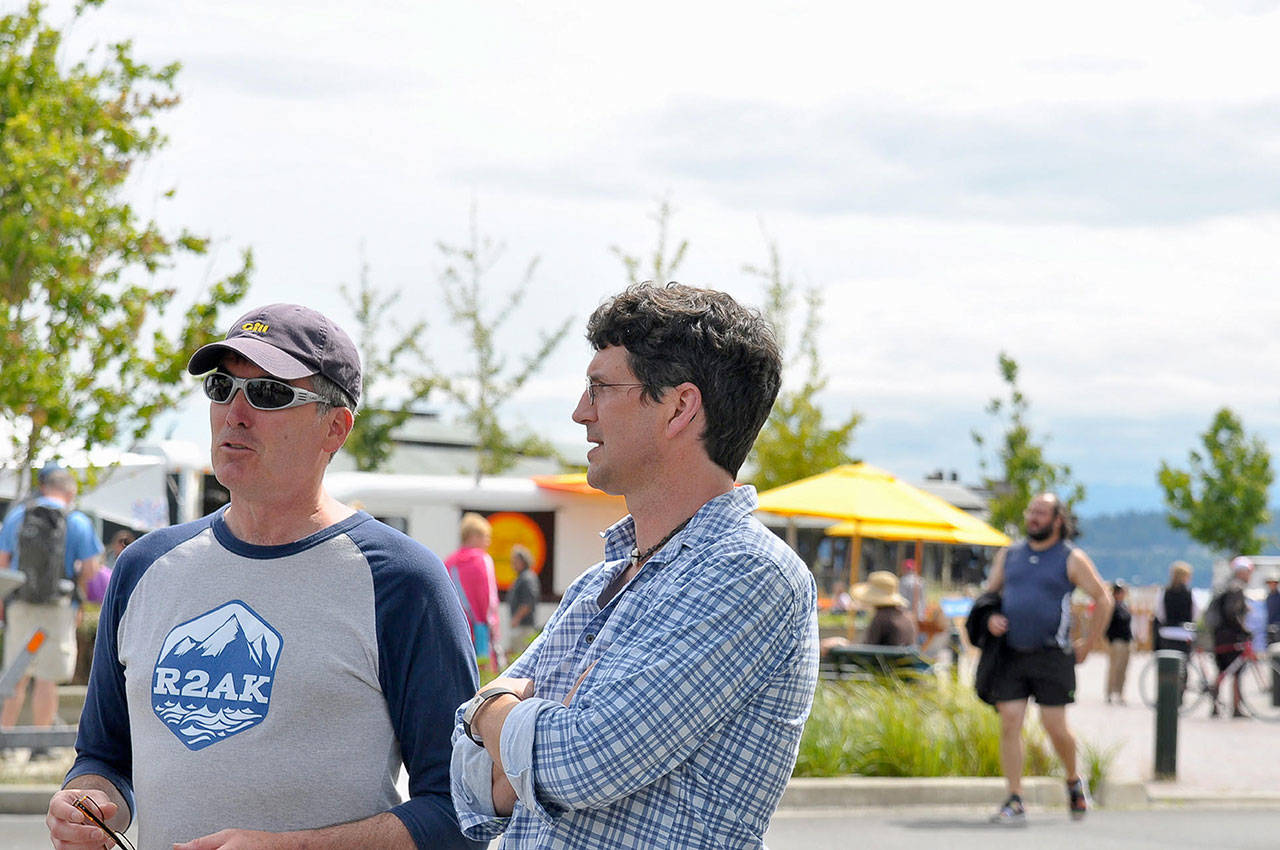 Race boss Daniel Evans, right, talks to an unidentified racer in Port Townsend at the starting line of last year&rsquo;s Race to Alaska. (Northwest Maritime Center)