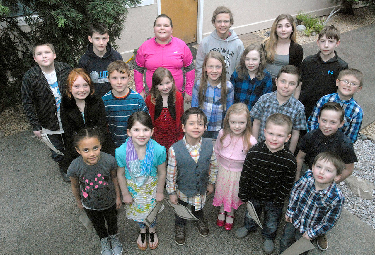 Winners of the annual Martin Luther King Jr. Race Equality Essay contest for the Port Angeles School District gather after receiving their certificates before the Port Angeles City Council. The winners include, front row from left, Kya Baker, kindergarten, Roosevelt School; Miriam Cobb, second grade, Franklin School; Levi Jimenez, first grade, Jefferson School; Evelyn Johnson, first grade, Roosevelt; Logan Wyatt Botero, kindergarten, Franklin; and Jonah Poovey, kindergarten, Jefferson; second row from left, Chloe Pearson, second grade, Hamilton School; Henry Zelenka, second grade, Hamilton; Addisyn Horton, first grade, Jefferson; Isabelle Felton, fifth grade, Dry Creek School; Lauryn Chapman, fifth grade, Roosevelt; Arlo Pullara, third grade, Roosevelt; Milo Smith, third grade, Roosevelt; and Nicholas Morrison, third grade, Jefferson; and back row from left, Brodey Jacobs, fourth grade, Roosevelt; Cole Beeman, fourth grade, Roosevelt; Liz Munro, fourth grade, Jefferson; Jackson Tesreau, fifth grade, Franklin; Lillien Erlwein, sixth grade, Franklin; and Bryant Hoch, sixth grade, Jefferson. Not pictured: Zackary Pierce, sixth grade, Roosevelt. (Keith Thorpe/Peninsula Daily News)