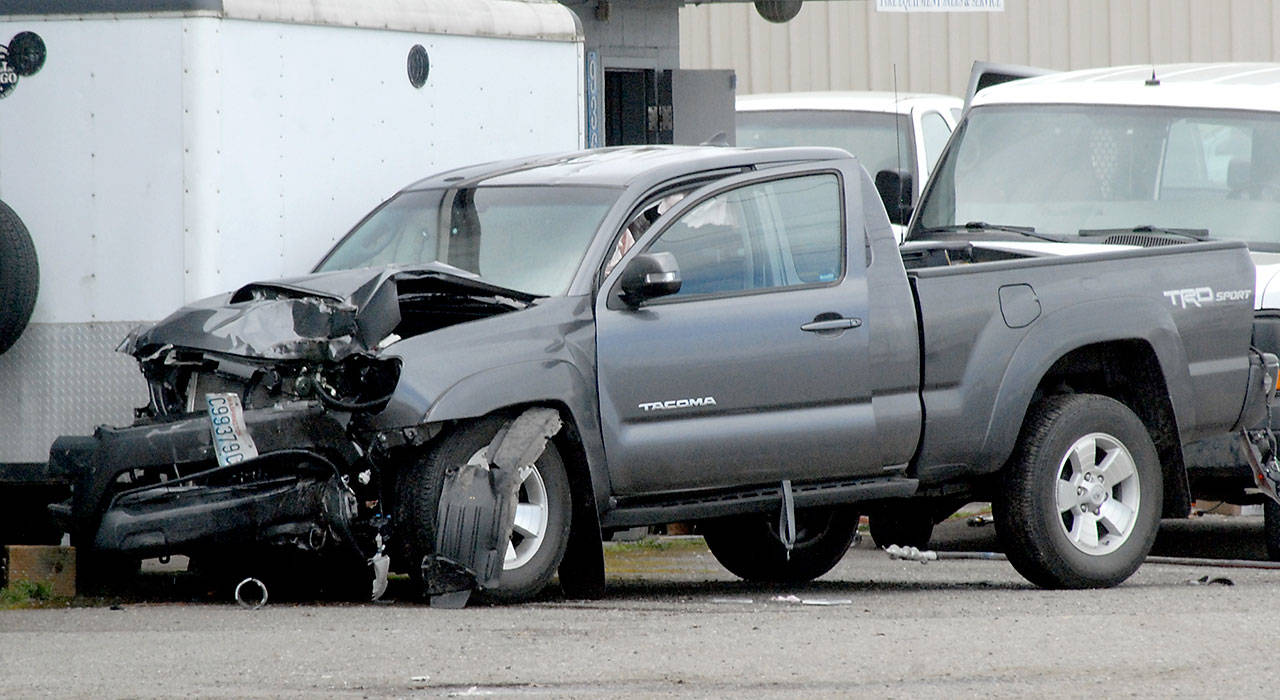A pickup truck sits in front of Fire Chief Equipment at 936 Marine Drive after smashing through a utility pole Friday in Port Angeles. (Keith Thorpe/Peninsula Daily News)