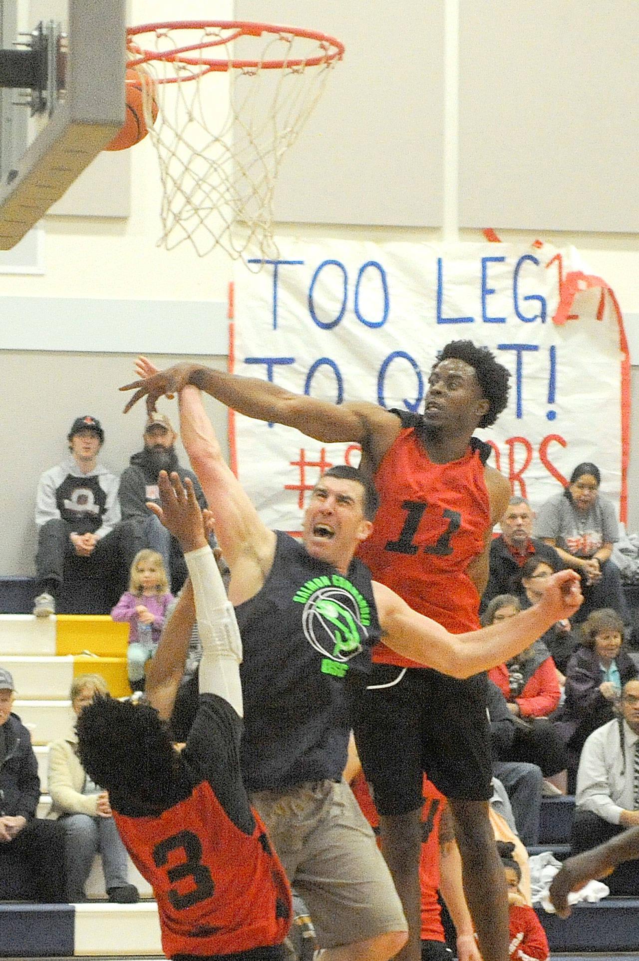 Lonnie Archibald/for Peninsula Daily News Kasey Ulin (center), playing for the Olympic Sporting Goods of Forks puts up a shot between defenders Jalen Ballard (3) and Terrell Mack (11) in the championship game during the Nate Crippen Memorial Tournament played Sunday at Forks High School. NW Dons of Portland, Ore., defeated Olympic Sporting Goods 80 to 68 to take the championship in the upper division. The Breakwater Boys of Clallam and Neah Bay took first in the lower division.