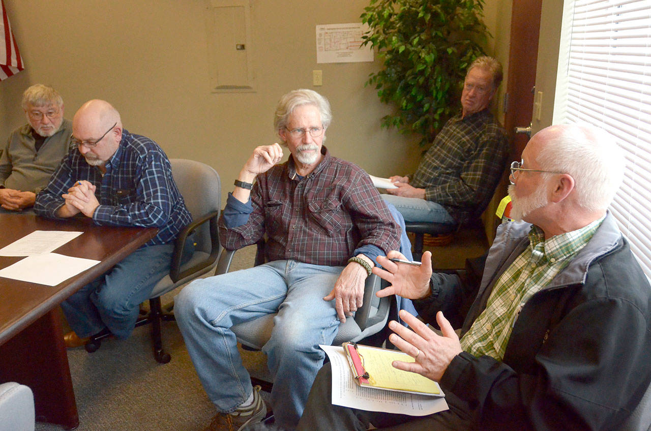 COAST chairman Carl Hanson, at right, speaks with Port Townsend City Council member Robert Grey at a meeting regarding the city’s new year-round homeless shelter. Representatives from OlyCAP and multiple local organizations were also present. (Cydney McFarland/Peninsula Daily News)